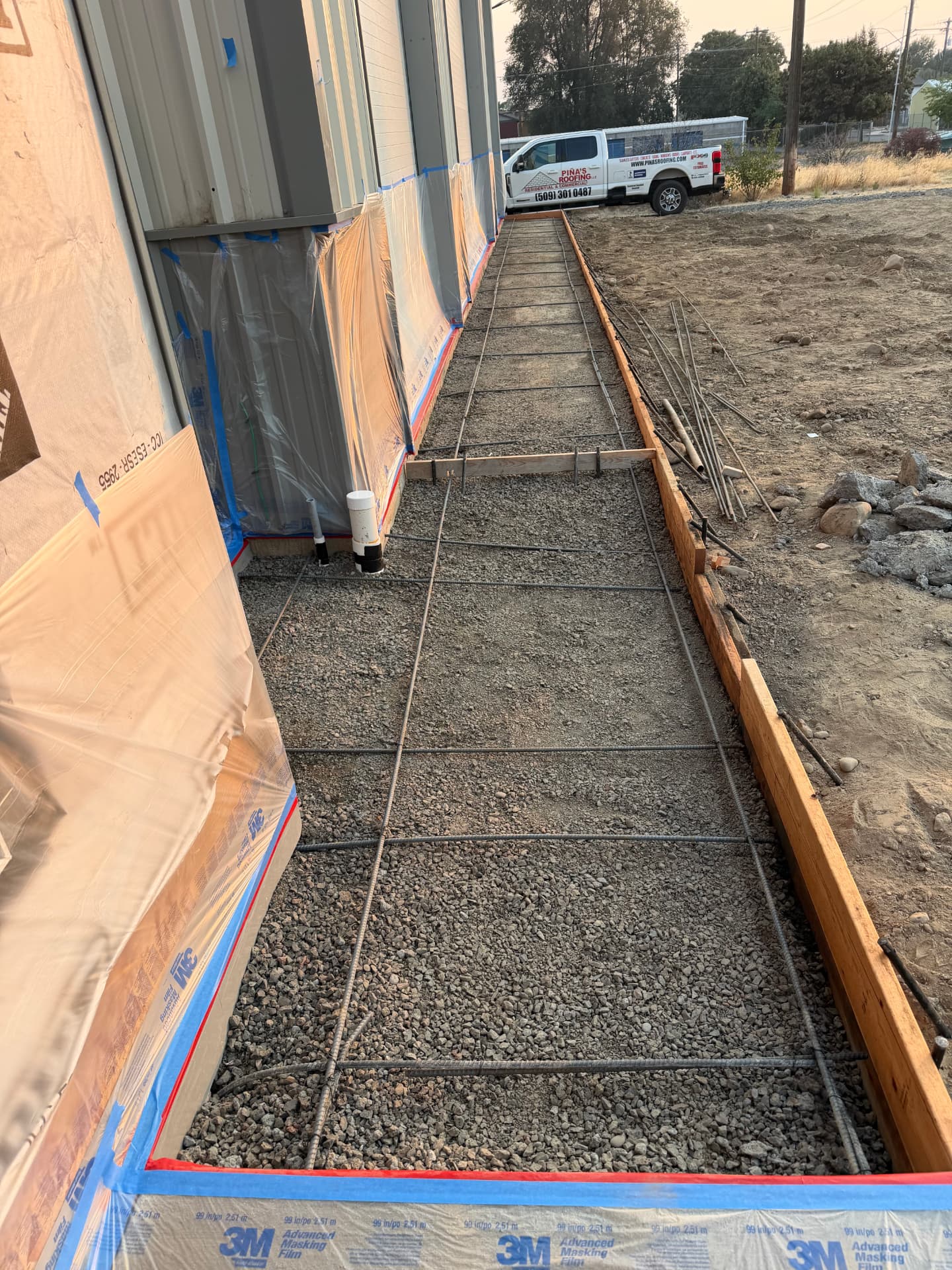 Formed and rebar-reinforced walkway prepared for concrete at a Piña's Roofing jobsite
