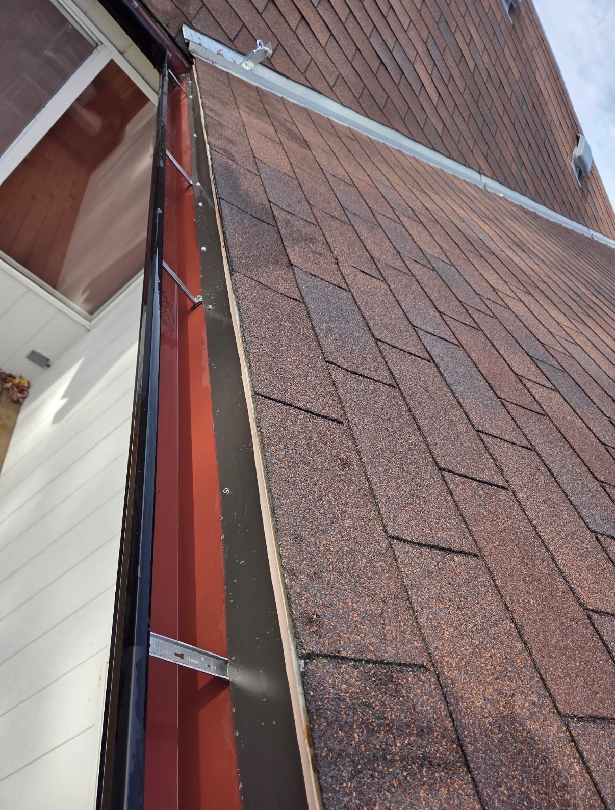 Close-up of architectural shingle roof with new flashing and drip edge detail