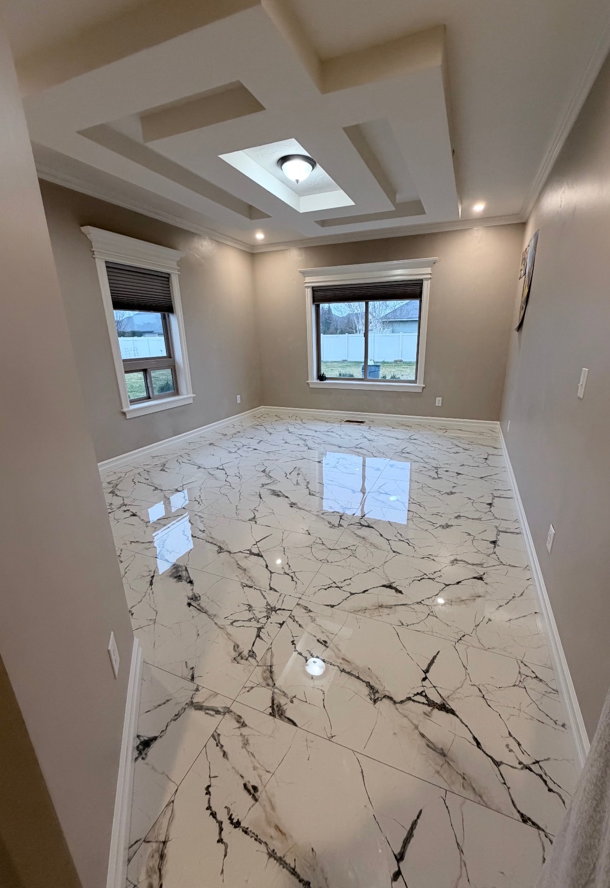 Finished interior remodel with coffered ceiling and marble tile floor